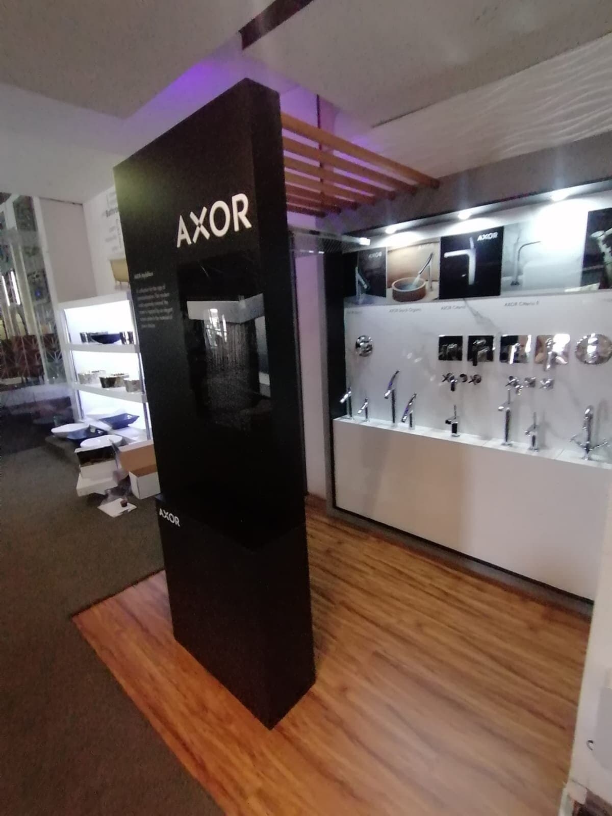 AXOR showroom fit-out with a freestanding display tower and wall-mounted tap displays