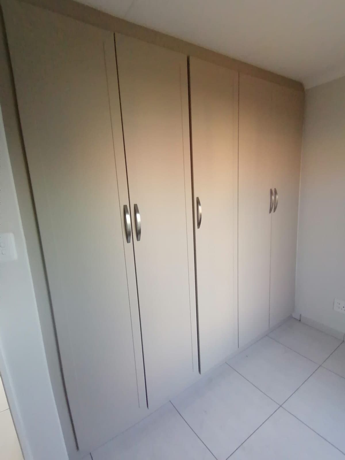 Built-in wardrobe with floor-to-ceiling cupboard doors