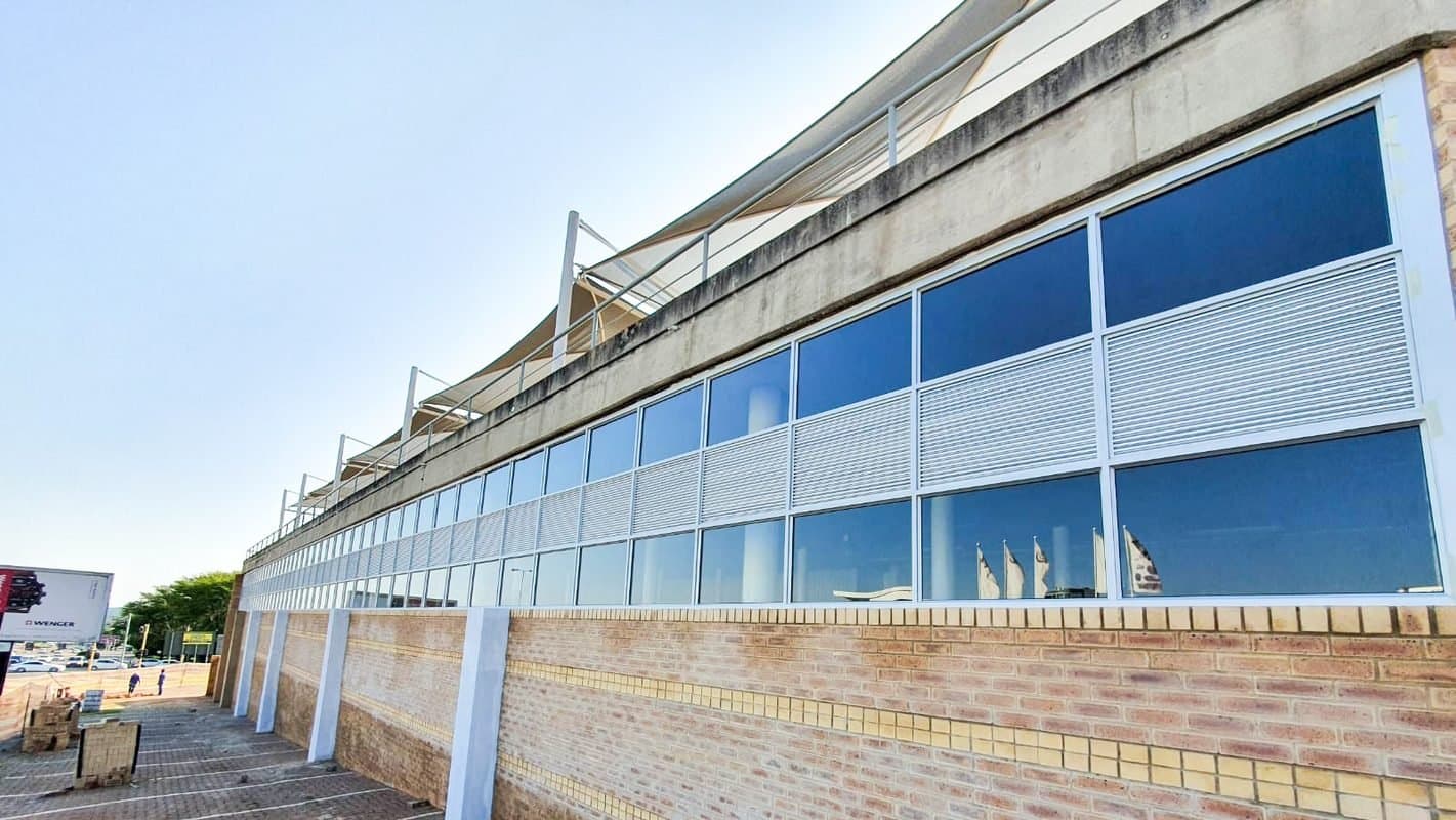 Aluminium-framed glazing installed along a commercial building facade in Menlyn, Pretoria